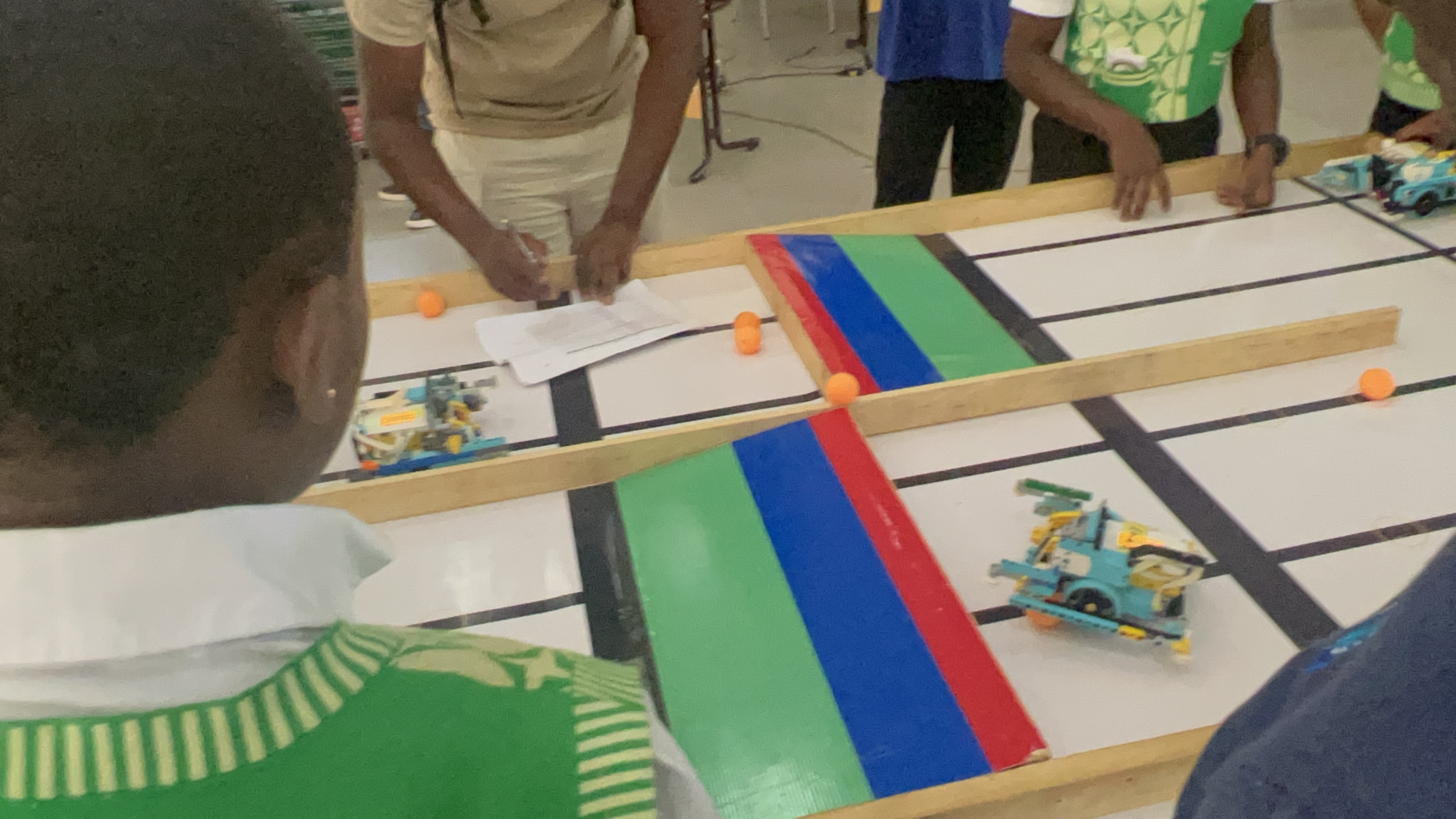 Students and mentors working on a robotics training track