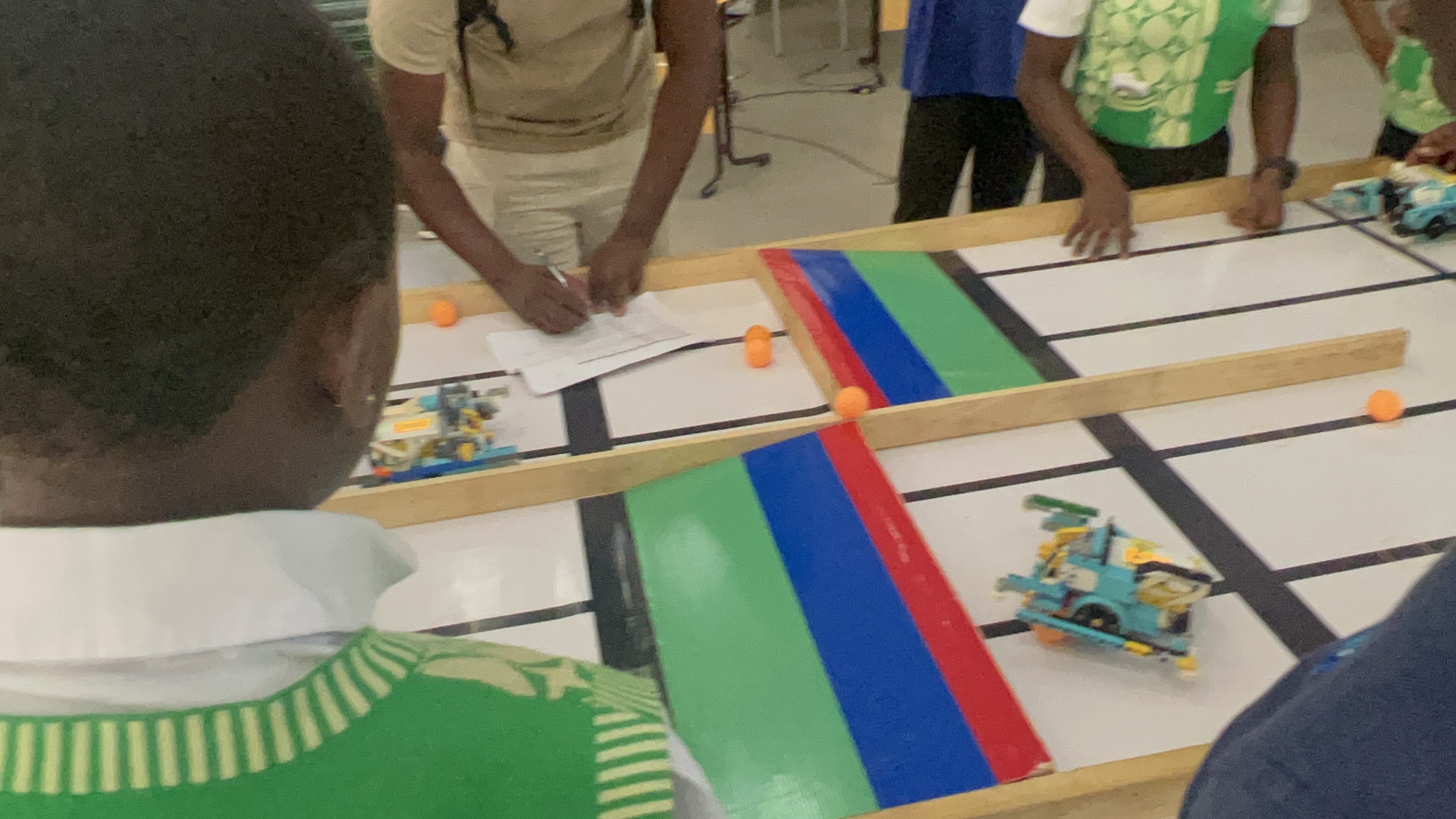 Robotics team members preparing a robot for a track challenge